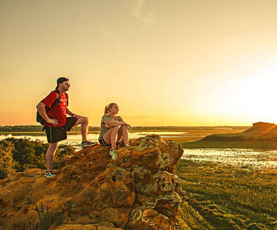 image of two hikers at sunrise